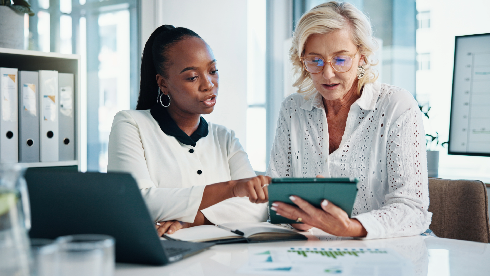 Two women looking at something on a tablet PC
